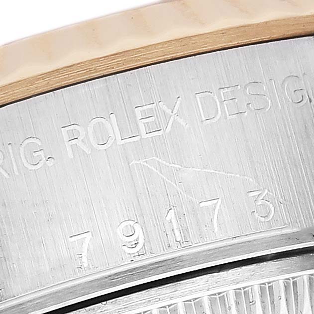 The image shows an angled close-up of the engraved model number on the case of a Rolex Datejust 79173 Women's Steel and Gold (two tone) Mother of Pearl Dial 79173 Women's Steel and Gold (two tone) Mother of Pearl Dial watch.