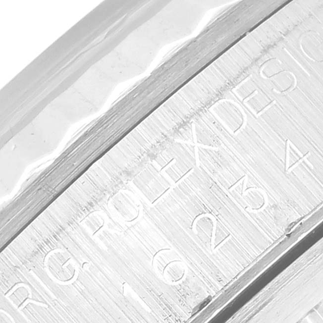 This close-up image shows the engraved serial number on the side of a Rolex Datejust 16234 Men's Stainless Steel Silver Dial 16234 Men's Stainless Steel Silver Dial model.