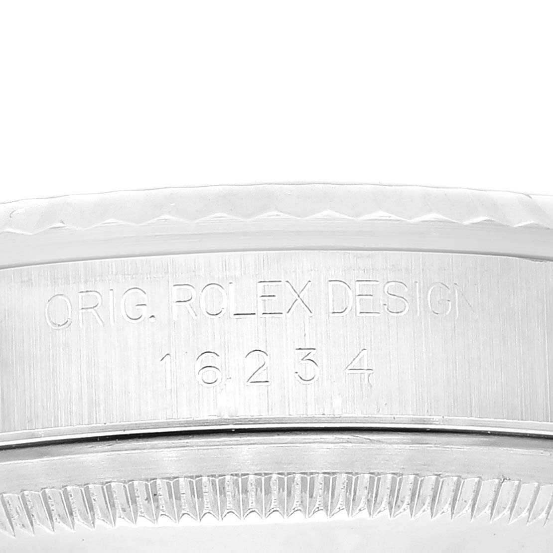 The image shows a close-up of the side of the case and the bezel of a Rolex Datejust 16234 Men's Stainless Steel Black Dial 16234 Men's Stainless Steel Black Dial model, with the model number and “ORIG. ROLEX DESIGN” engraving.