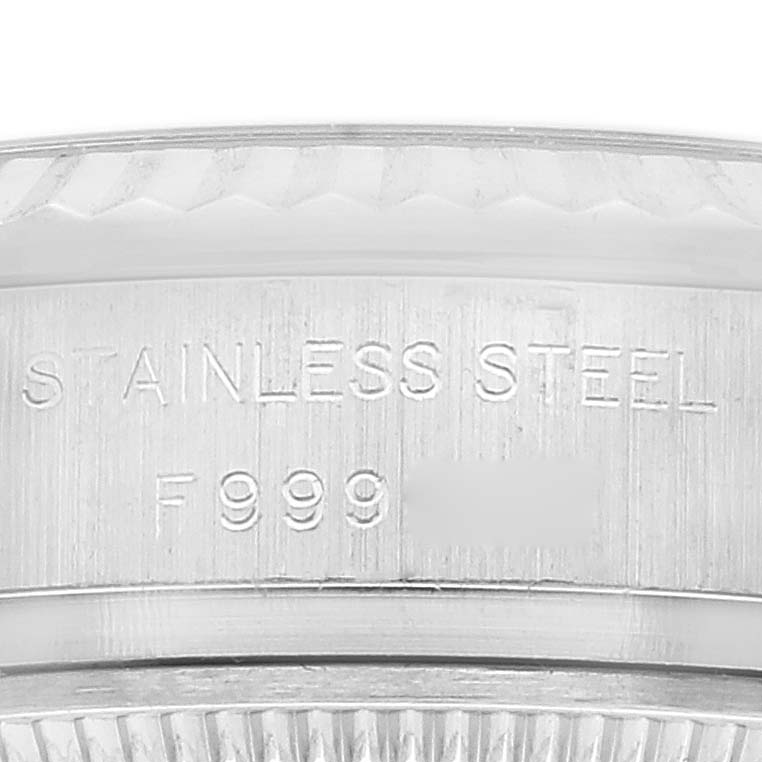 This close-up image shows the stainless steel text partially engraved on the side of a Rolex Datejust 179174 Women's Stainless Steel Mother of Pearl Dial 179174 Women's Stainless Steel Mother of Pearl Dial watch case.