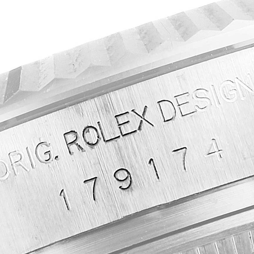 The image shows a close-up of the case side with etching on a Rolex Datejust 179174 Women's Stainless Steel Silver Dial 179174 Women's Stainless Steel Silver Dial watch, highlighting "ROLEX DESIGN" and the model number.