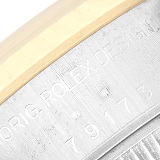 The image shows a close-up of the side engraving and bezel of a Rolex Datejust 79173 Women's Steel and Gold (two tone) Champagne Dial 79173 Women's Steel and Gold (two tone) Champagne Dial watch.