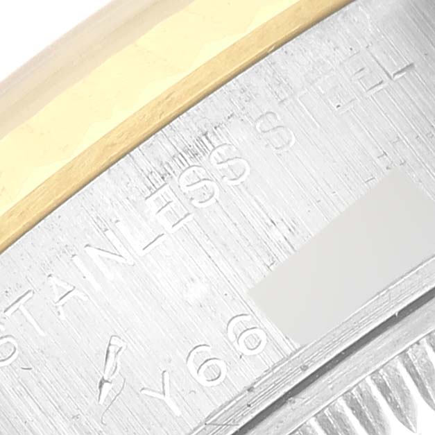 The image shows a close-up of the case back of a Datejust model by Rolex, highlighting the stainless steel and gold details.