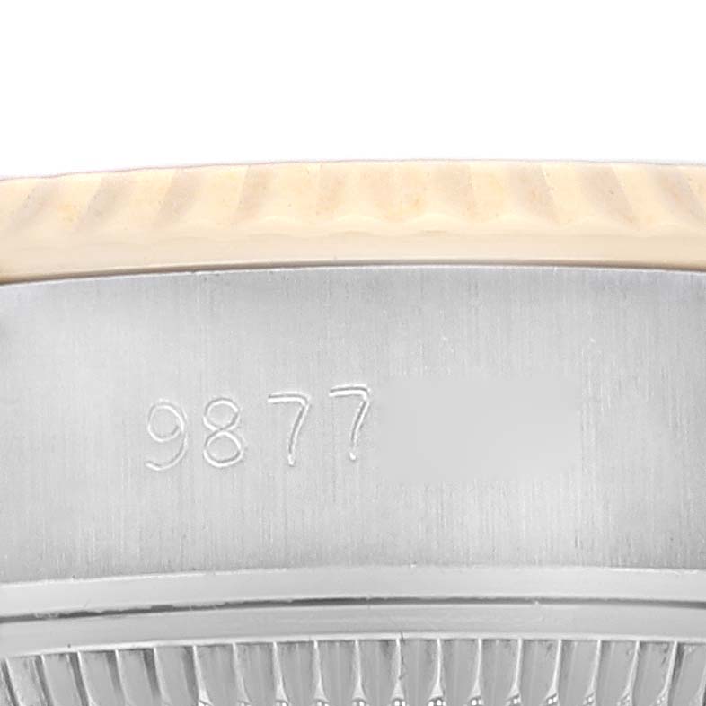 This image shows a close-up of the side case and part of the bezel of a Rolex Datejust 69173 Women's Steel and Gold (two tone) Champagne Dial 69173 Women's Steel and Gold (two tone) Champagne Dial watch, with partial serial number engraving.