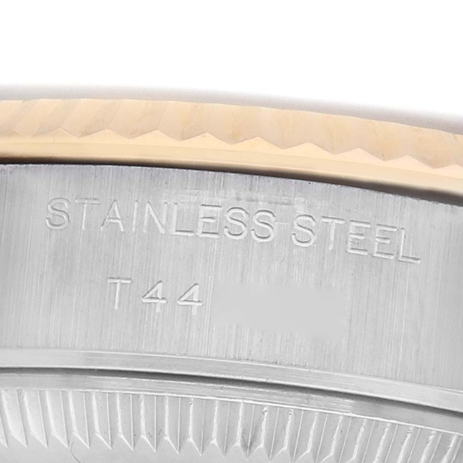 The image shows a close-up of a Rolex Datejust 69173 Women's Steel and Gold (two tone) Grey Dial's stainless steel bezel and part of the case.