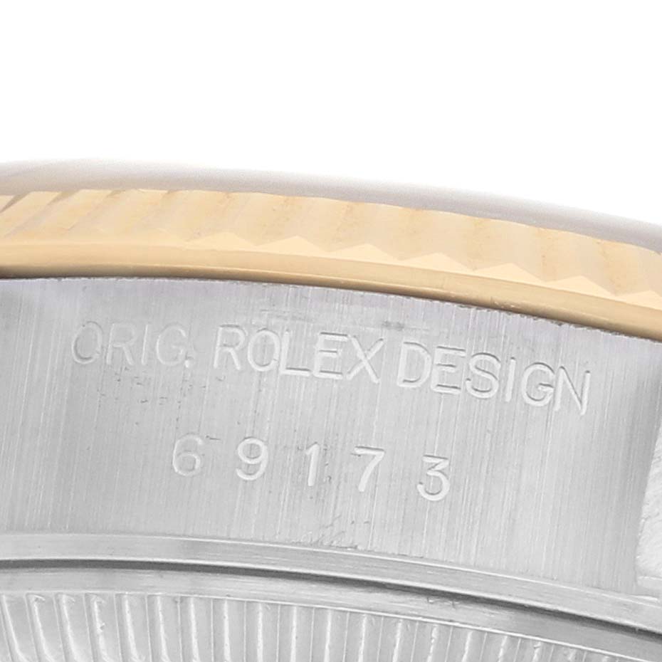 The image shows a close-up of the case side of a Rolex Datejust 69173 Women's Steel and Gold (two tone) Grey Dial, highlighting the model number and design engraving.