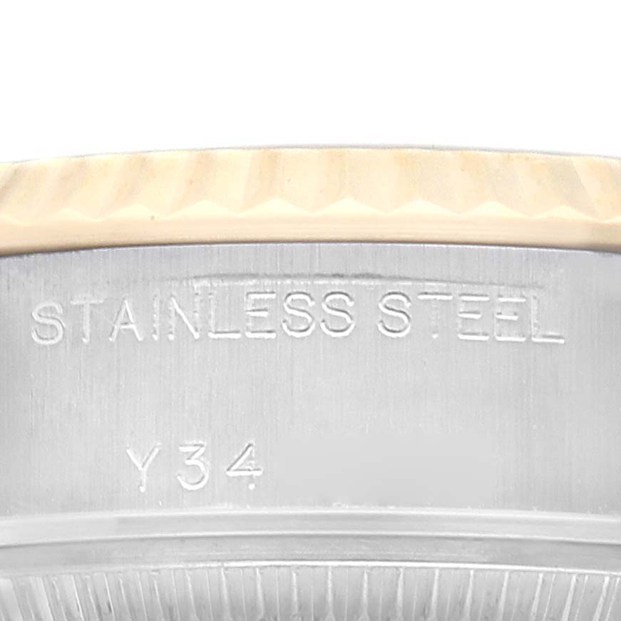This close-up image shows the side of a Rolex Datejust 79173 Women's Steel and Gold (two tone) Champagne Dial, highlighting the stainless steel marking and part of the fluted bezel.