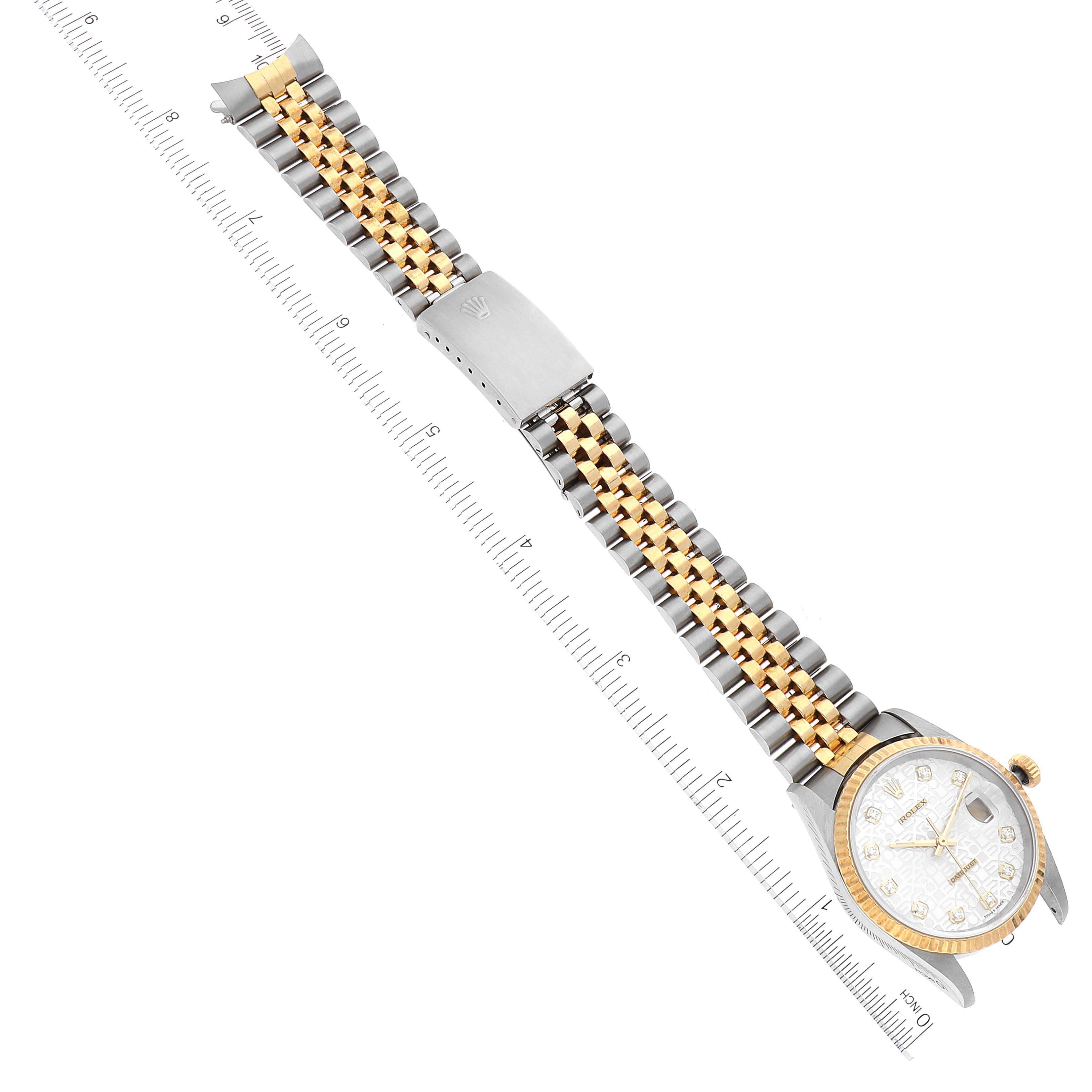 This image shows a Rolex Datejust 16233 Men's Steel and Gold (two tone) Silver Dial 16233 Men's Steel and Gold (two tone) Silver Dial watch at an angled top view, highlighting the face, bracelet, and clasp next to a ruler.