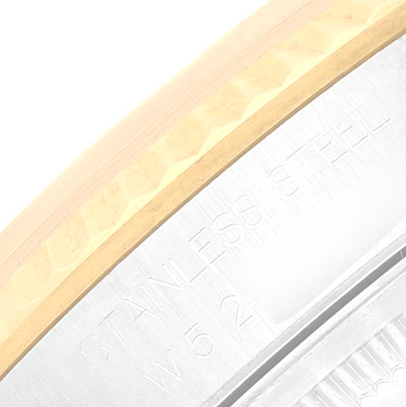 The image shows a close-up of the bezel edge of a Rolex Datejust 16233 Men's Steel and Gold (two tone) Silver Dial 16233 Men's Steel and Gold (two tone) Silver Dial watch, highlighting its stainless steel and gold components.