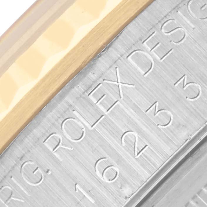 This is a close-up of the bezel and engraving on a Rolex Datejust 16233 Men's Steel and Gold (two tone) Grey Dial 16233 Men's Steel and Gold (two tone) Grey Dial watch case.