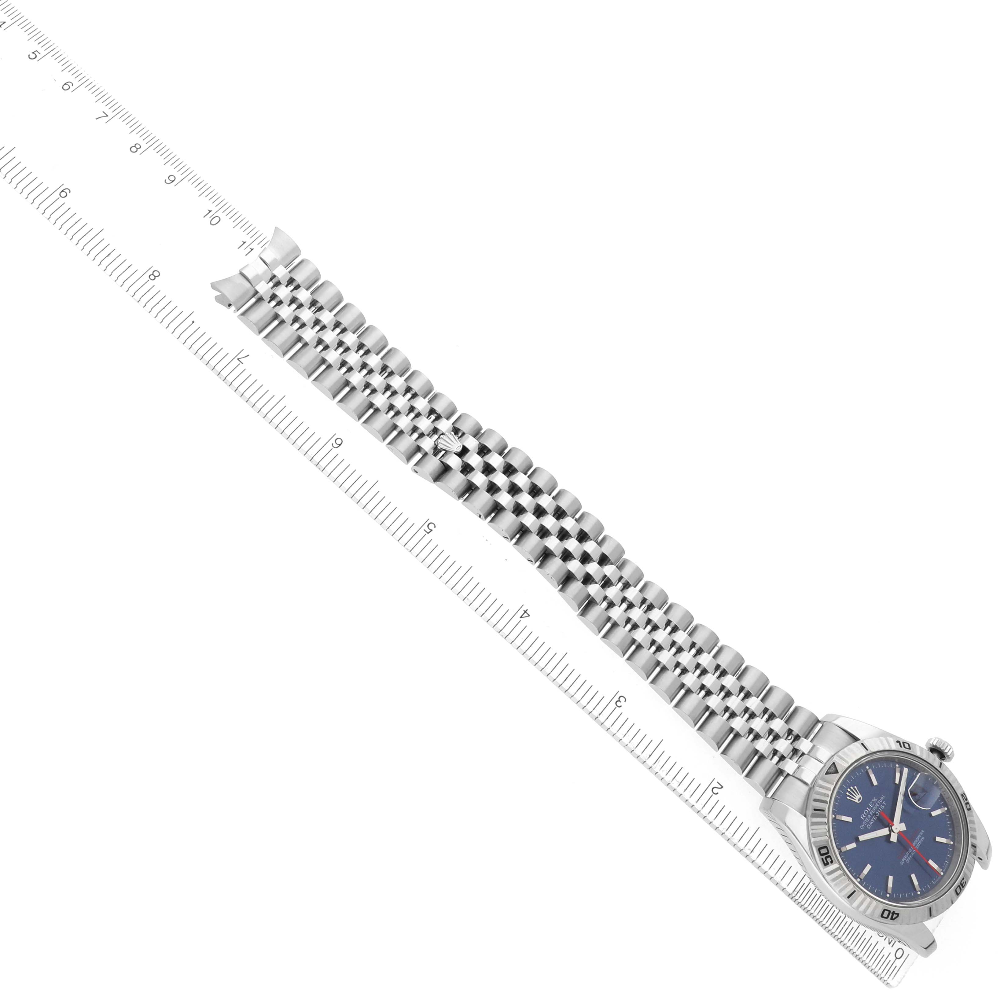 The Rolex Turn-o-Graph 116264 Men's Stainless Steel Blue Dial watch is shown from a top-down angle, displaying the face and full bracelet alongside a ruler for scale.
