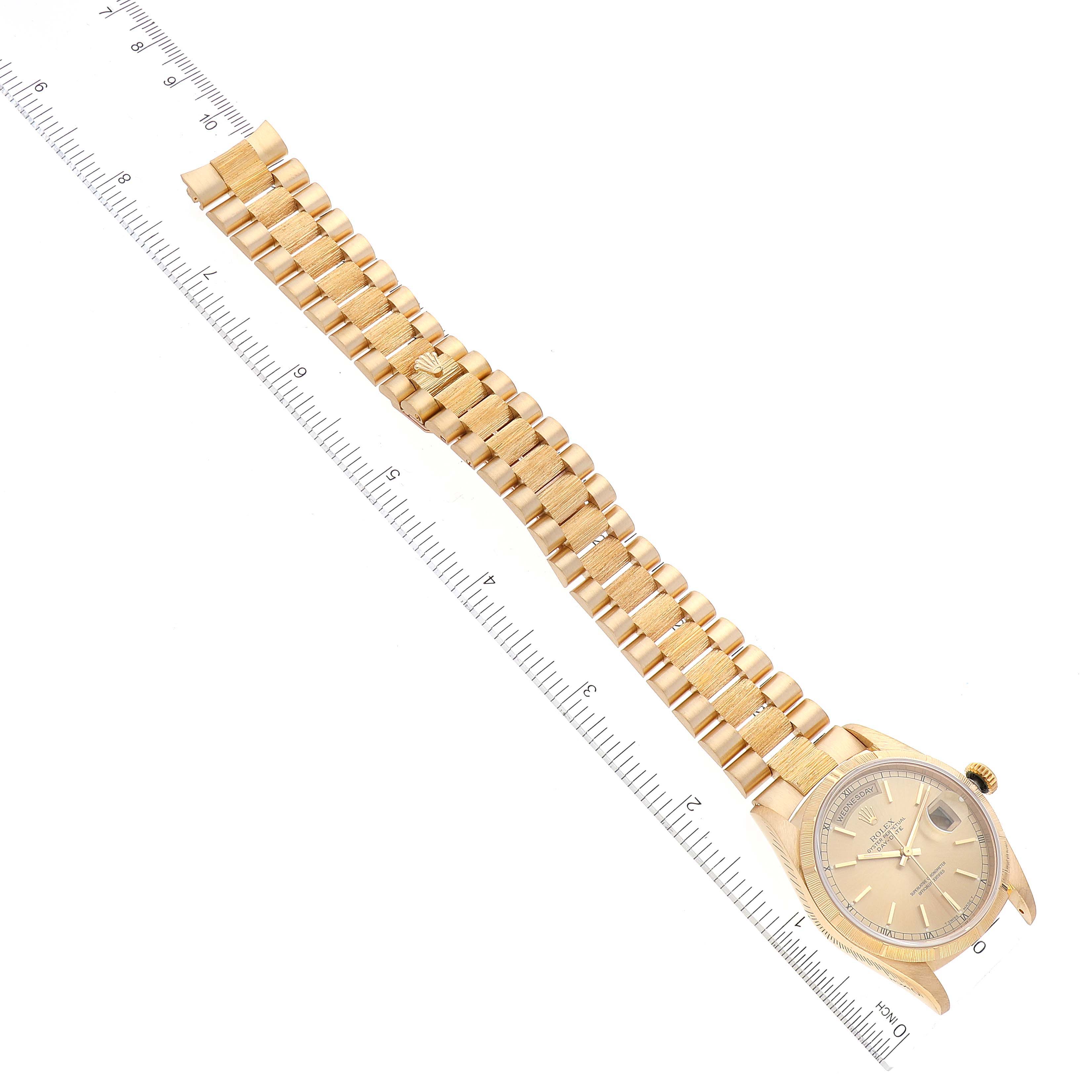 The image shows a Rolex President 18248 Men
s Yellow Gold Champagne Dial 18248 Men
s Yellow Gold Champagne Dial model watch from a top-down angle, featuring the entire watch case and bracelet, with a ruler for scale.