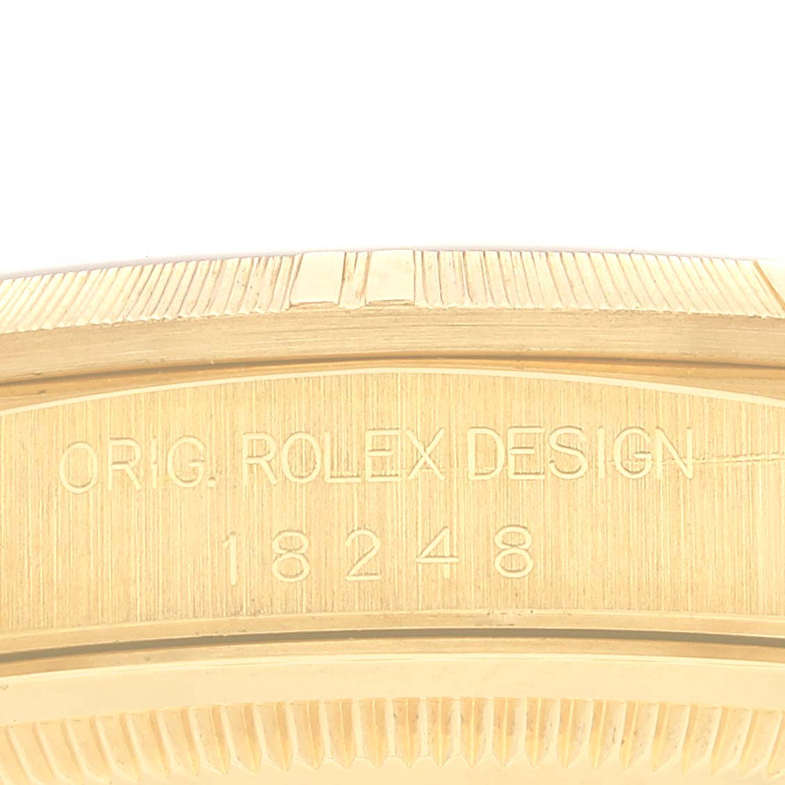 The image shows a close-up of the engraved side of a Rolex President 18248 Men
s Yellow Gold Champagne Dial 18248 Men
s Yellow Gold Champagne Dial model watch, highlighting "ORIG. ROLEX DESIGN 18248."