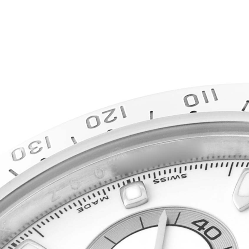 The image shows a close-up of the Rolex Daytona 116520 Men's Stainless Steel White Dial watch face, highlighting the bezel and part of the dial with hour markers.