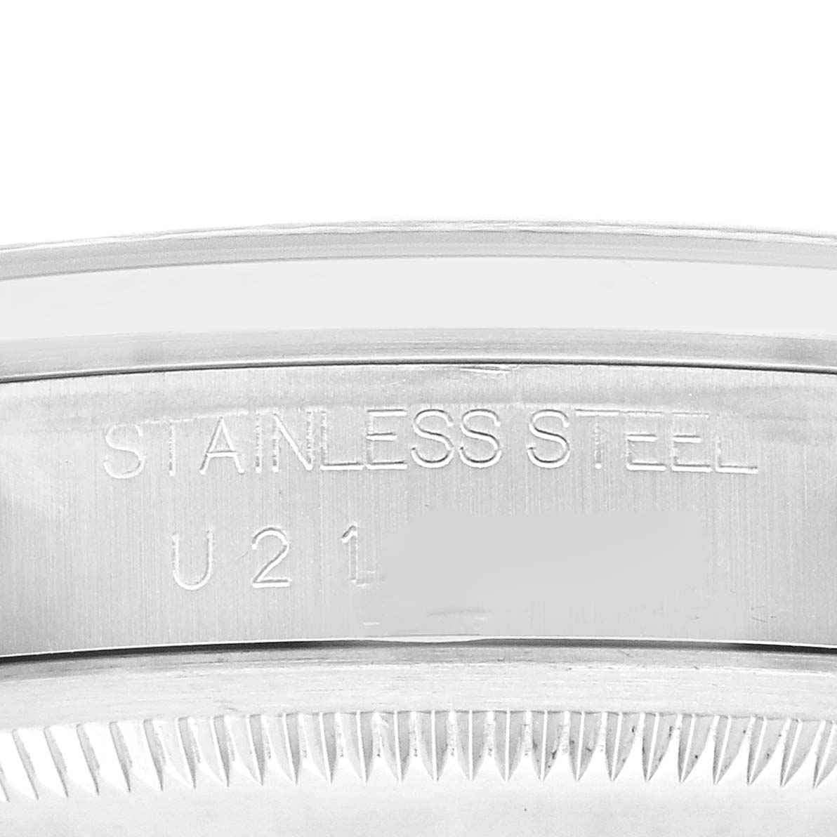 The image shows a close-up of the Rolex Explorer 14270 Men's Stainless Steel Black Dial's case side featuring "STAINLESS STEEL" engraving.