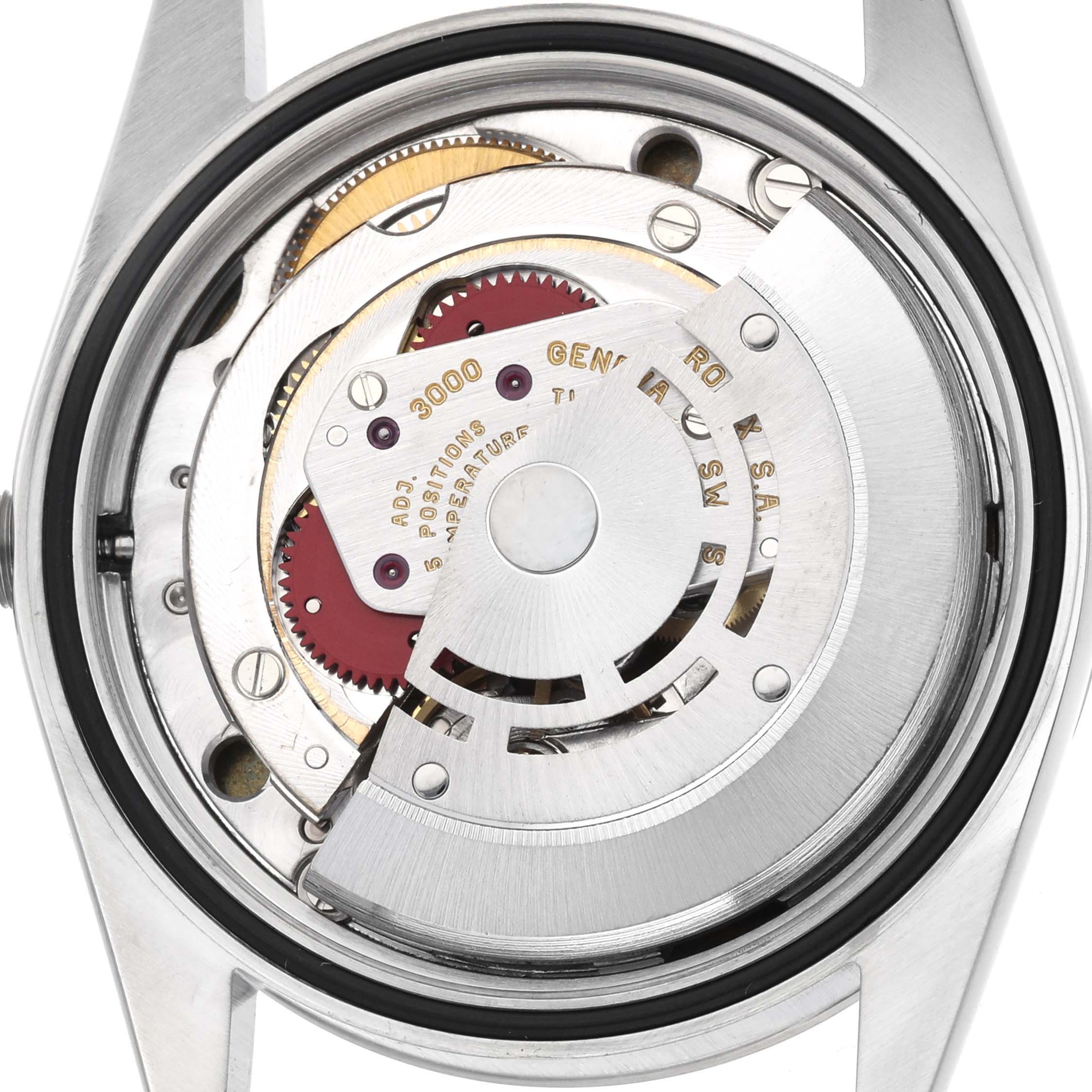 The image shows the movement of a Rolex Explorer 14270 Men's Stainless Steel Black Dial watch, captured from the back, highlighting the rotor and inner components.