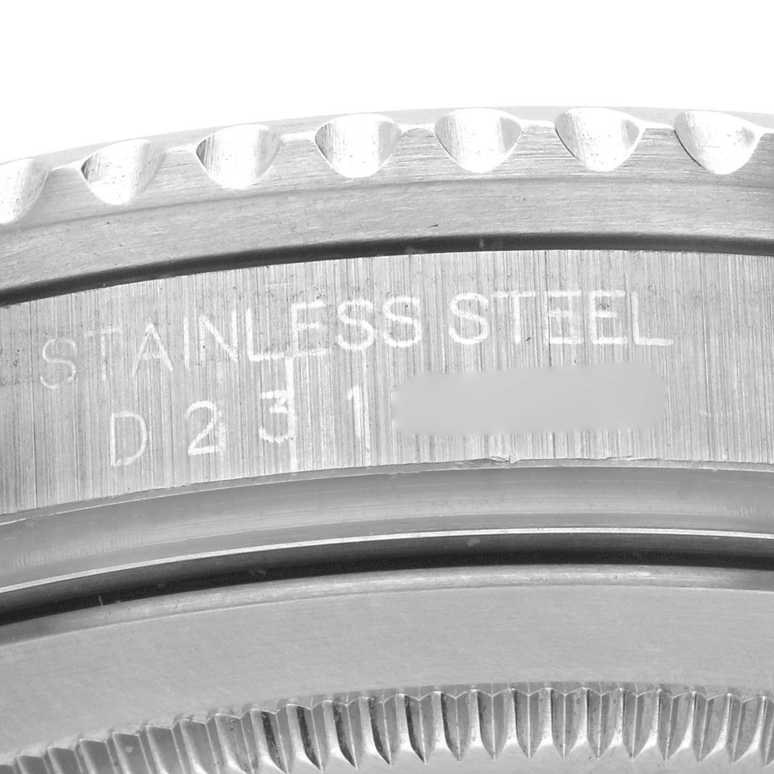 The image shows a close-up of the Rolex GMT-Master 16710 Men
s Stainless Steel Black Dial 16710 Men
s Stainless Steel Black Dial
s stainless steel case with part of the serial number.