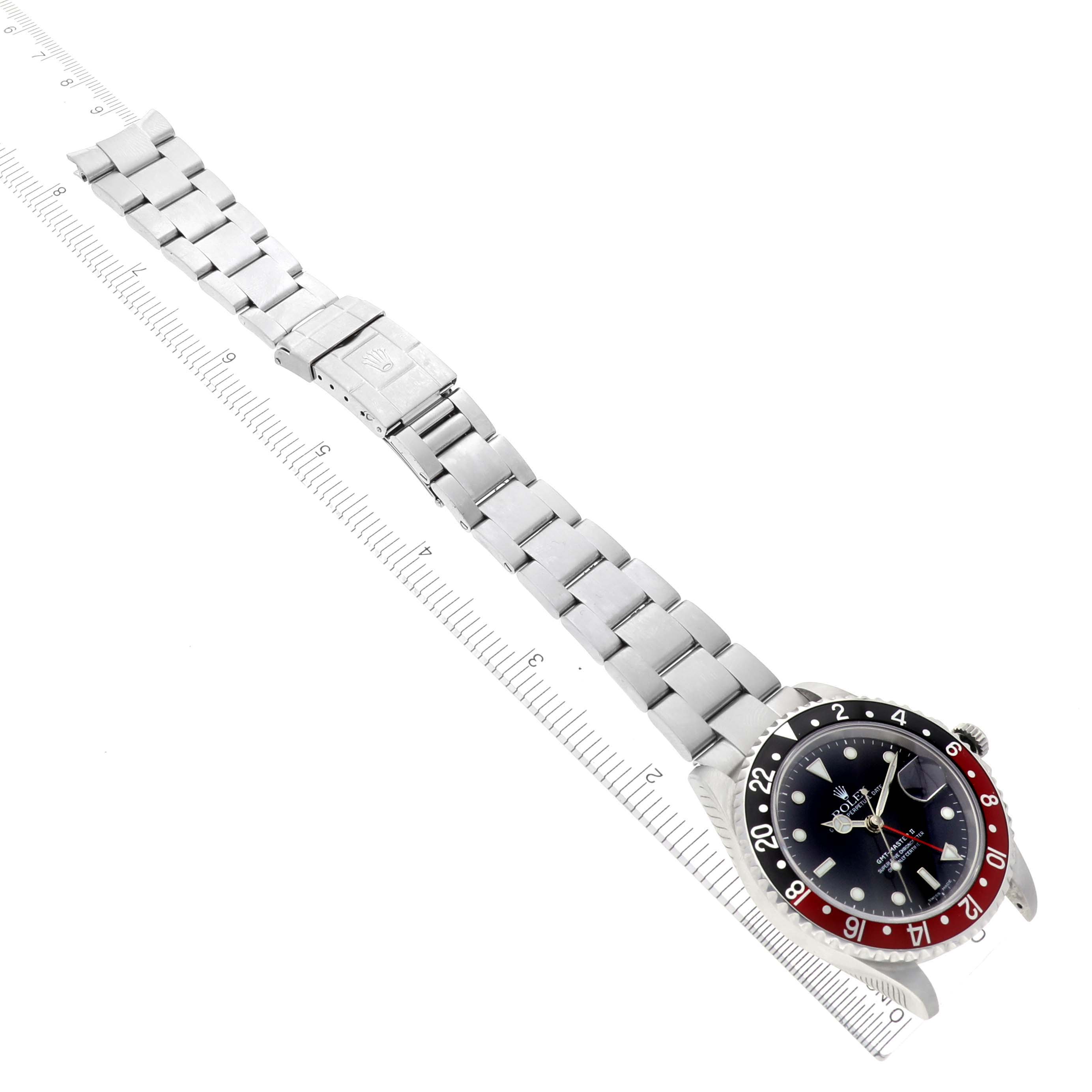 The image shows a Rolex GMT-Master 16710 Men
s Stainless Steel Black Dial 16710 Men
s Stainless Steel Black Dial watch laid flat, displaying its full metal bracelet and face from a top-down angle.