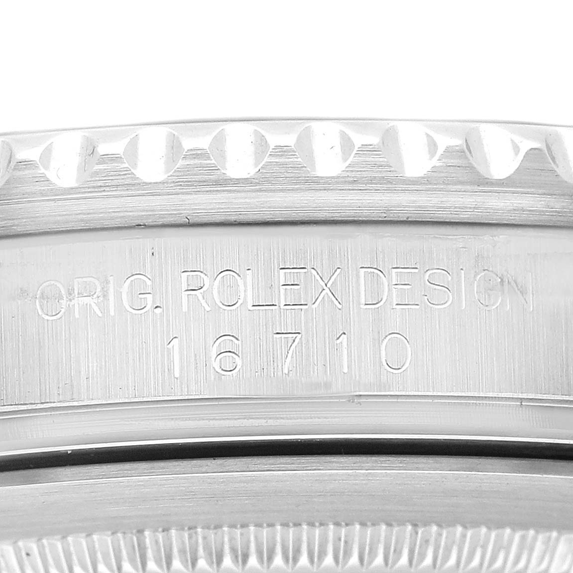 The image shows an angled close-up of the side engraving and bezel of the Rolex GMT-Master 16710 Men
s Stainless Steel Black Dial 16710 Men
s Stainless Steel Black Dial model 16710.