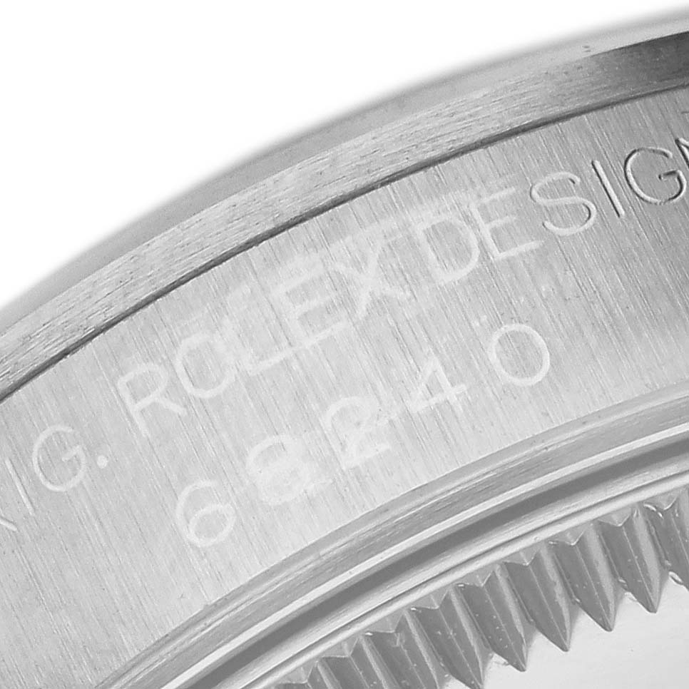 The image shows a close-up of the case back and edge of a Rolex Mid-Size 68240 Women's Stainless Steel Pink Dial 68240 Women's Stainless Steel Pink Dial model with engraved details.