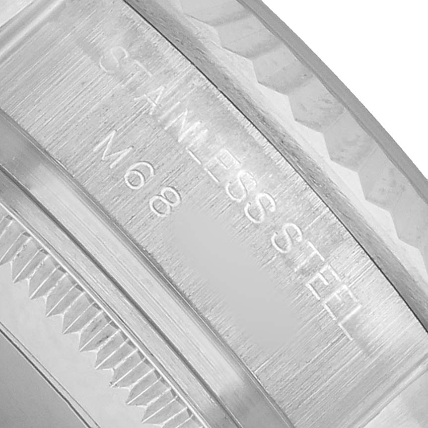 The image shows a close-up of the Oyster Perpetual Rolex's case edge, highlighting the "STAINLESS STEEL" engraving.