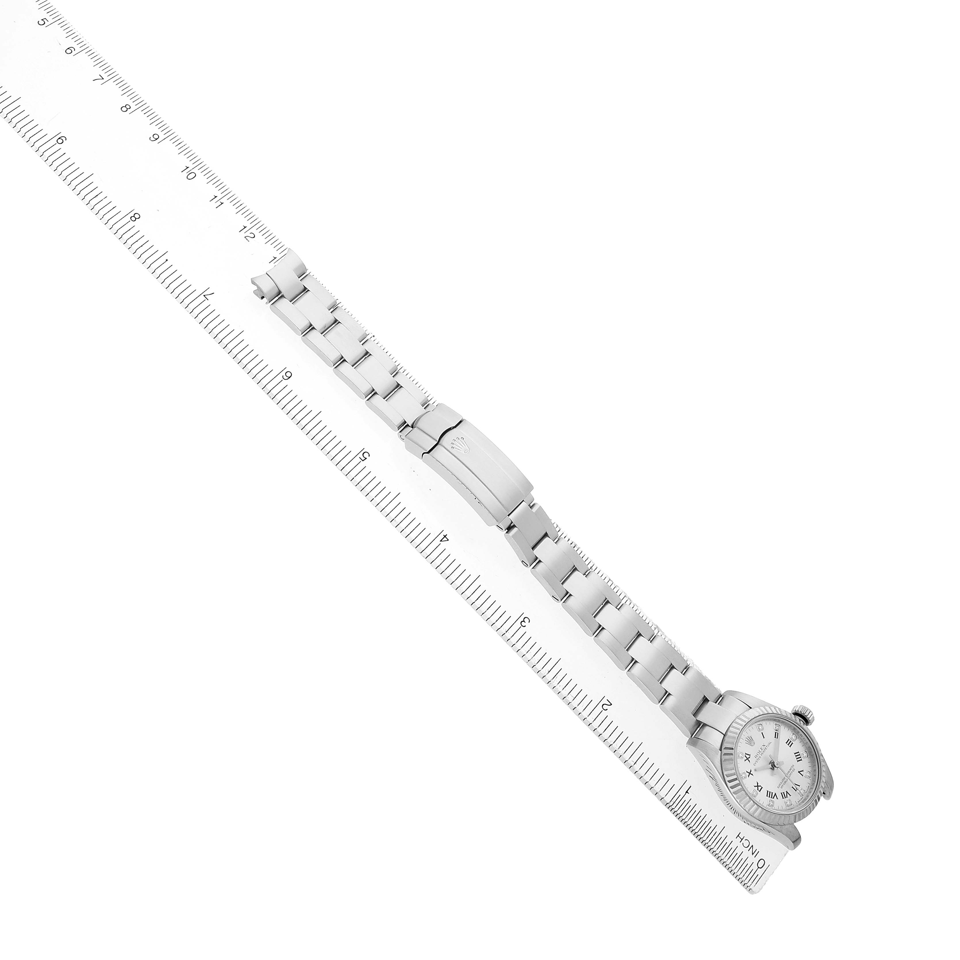 The Rolex Oyster Perpetual 176234 Women's Stainless Steel Silver Dial watch is shown from a top-down angle, highlighting the bracelet and clasp, with a ruler beside it for scale.