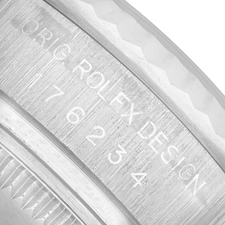 The image shows a close-up of the side edge of a Rolex Oyster Perpetual 176234 Women's Stainless Steel Silver Dial watch, focusing on its engraved serial and model number.