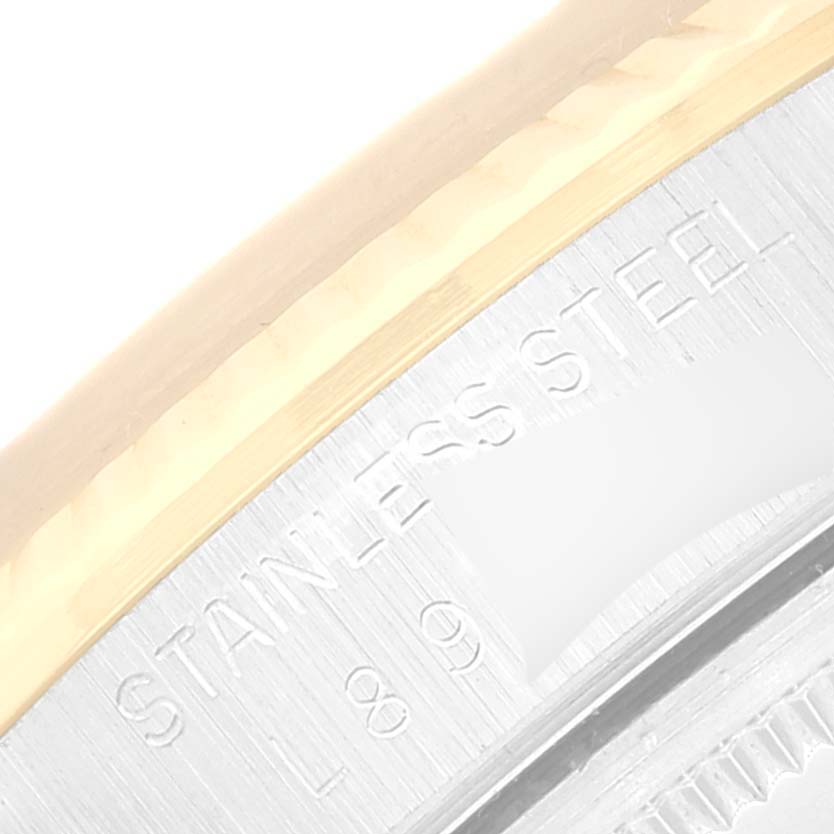 This image shows a close-up of the bezel and the engraved text on the side of a Rolex Oyster Perpetual 14233 Men
s Steel and Gold (two tone) Champagne Dial 14233 Men
s Steel and Gold (two tone) Champagne Dial watch.