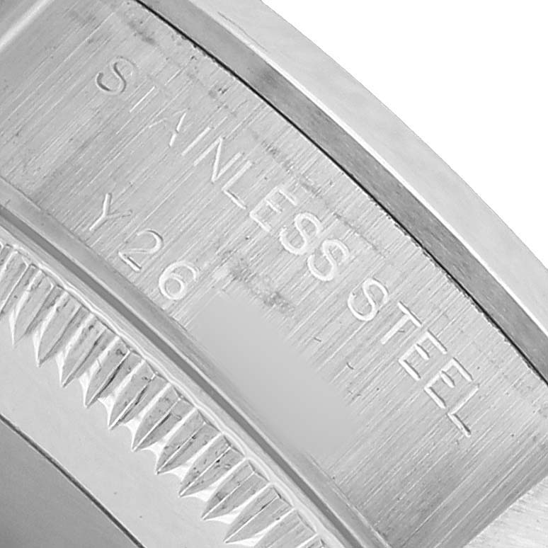 The image shows a close-up of the stainless steel bezel and engraved lettering on the Rolex Oyster Perpetual 76080 Women's Stainless Steel Silver Dial watch.