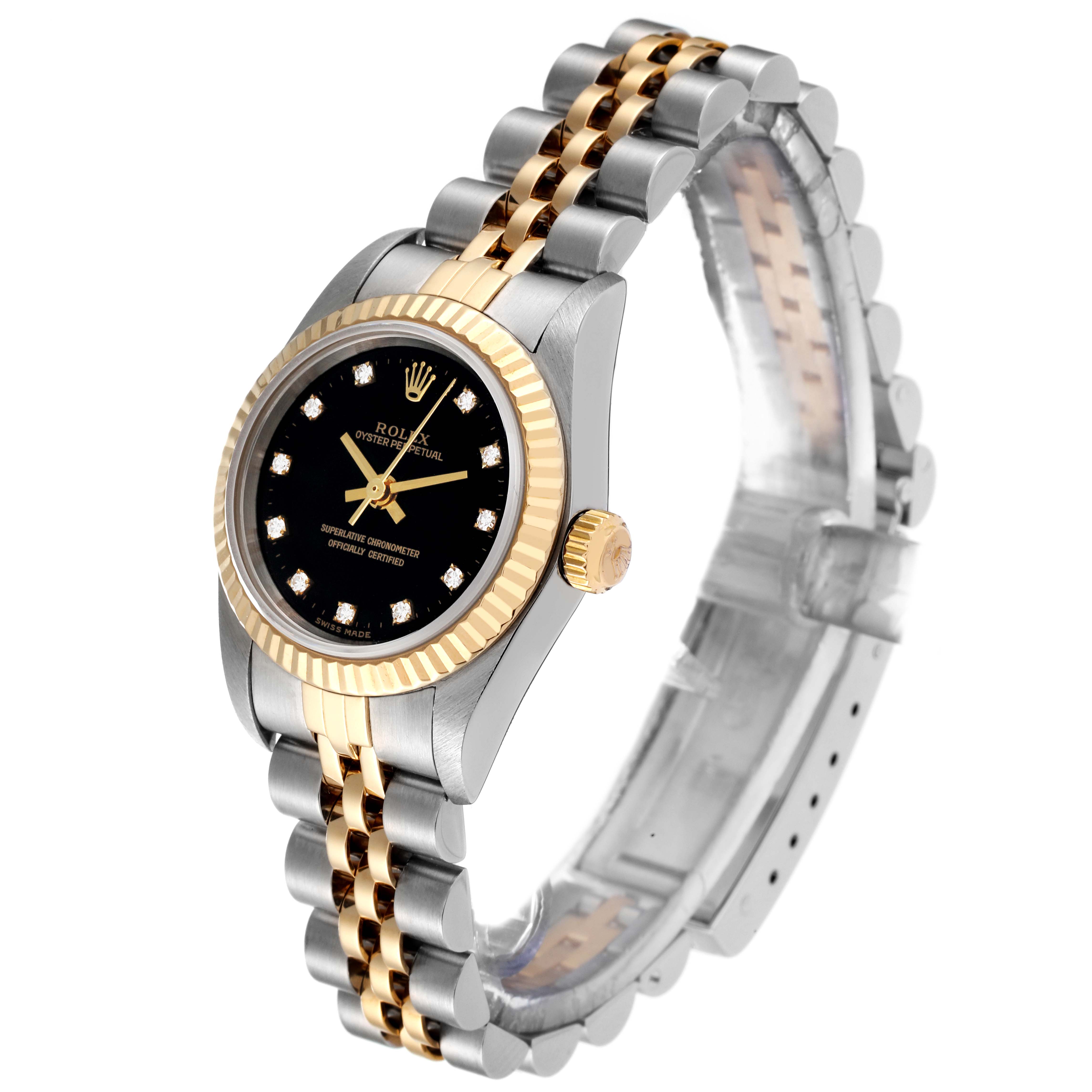 The Rolex Oyster Perpetual 76193 Women's Steel and Gold (two tone) Black Dial 76193 Women's Steel and Gold (two tone) Black Dial watch is shown at a slight angle, displaying its black dial, gold-and-steel bracelet, and fluted bezel.
