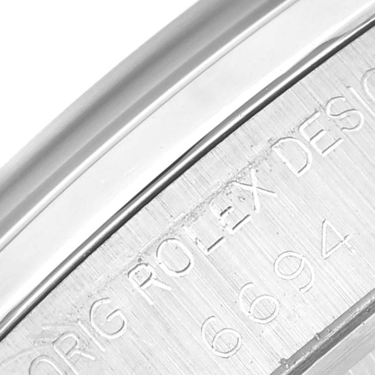 This image shows a close-up of the engraved case back of a Rolex Vintage Collection 6694 Men's Stainless Steel Black Dial 6694 Men's Stainless Steel Black Dial watch.