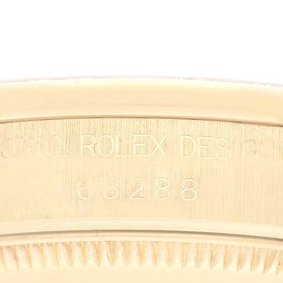 This close-up image shows the engraved reference number and part of the bezel of the Rolex President 68288 Women's Yellow Gold Champagne Dial 68288 Women's Yellow Gold Champagne Dial model watch.