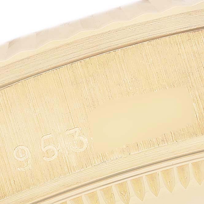 This close-up image shows the side engraving and fluted bezel of a Rolex President 68278 Women's Yellow Gold White Dial 68278 Women's Yellow Gold White Dial model watch.