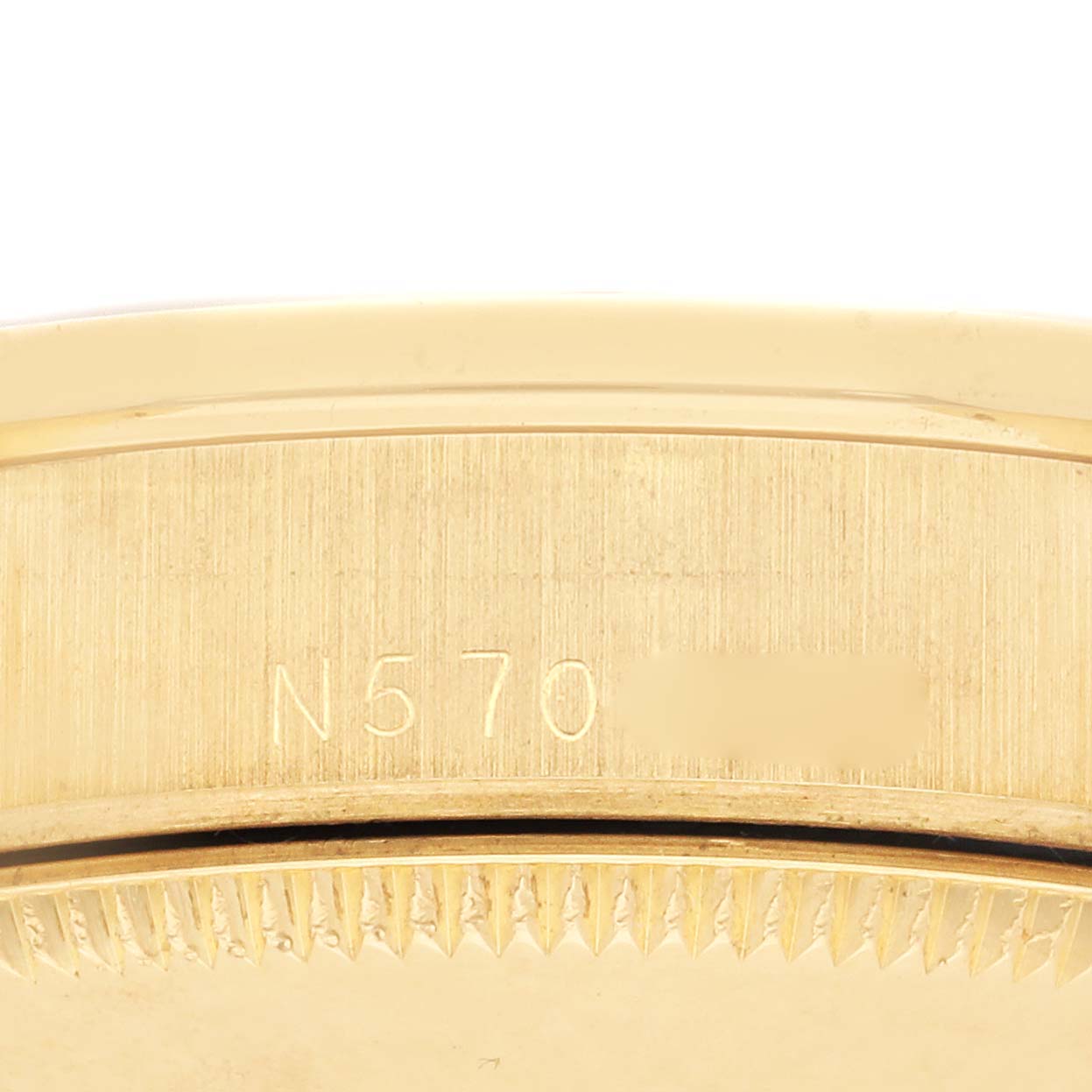 The image shows the side view of a Rolex Mid-Size 68288 Women's Yellow Gold Champagne Dial 68288 Women's Yellow Gold Champagne Dial model with a focus on the engraved serial number.