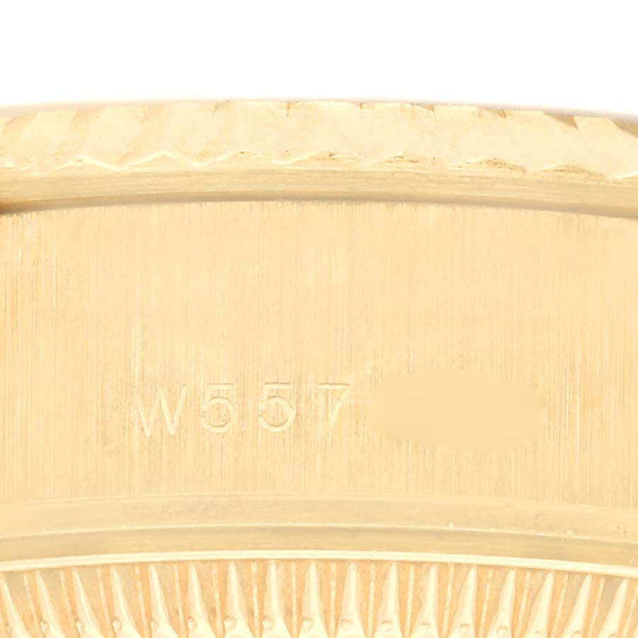 The image shows a close-up of the fluted bezel of a Rolex Datejust 69178 Women's Yellow Gold Champagne Dial 69178 Women's Yellow Gold Champagne Dial watch with engraving details.