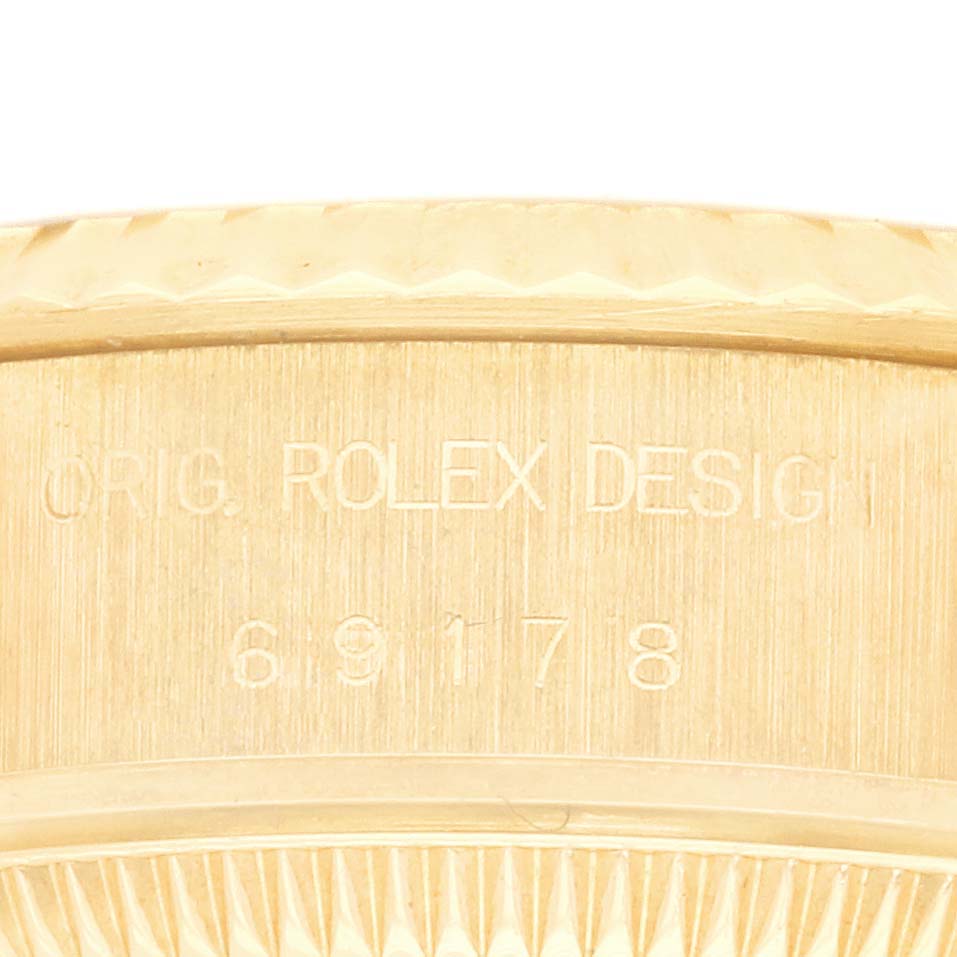 The image shows a close-up of the side of a Rolex Datejust 69178 Women's Yellow Gold Champagne Dial 69178 Women's Yellow Gold Champagne Dial watch case, featuring the model number engraved.