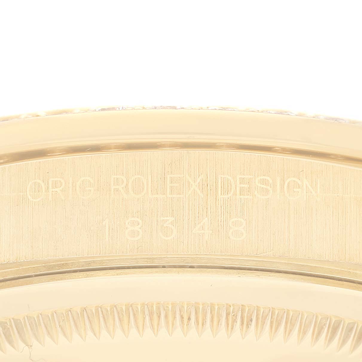 The image shows a close-up angle of the side of a Rolex President 18348 Men
s Yellow Gold Champagne Dial 18348 Men
s Yellow Gold Champagne Dial model, featuring the engraved design and model number "18348."