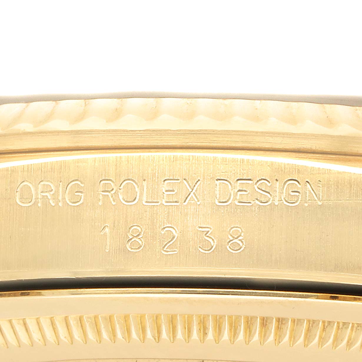 The image shows a close-up of the case side of a Rolex President 18238 Men's Yellow Gold Champagne Dial model, highlighting the engraved design number "18238."