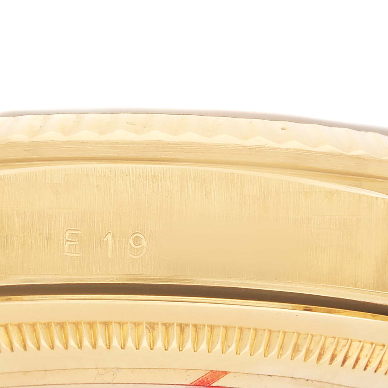 The image shows a close-up angle of the bezel and case edge of a Rolex President 18238 Men's Yellow Gold Champagne Dial watch with part of its dial.