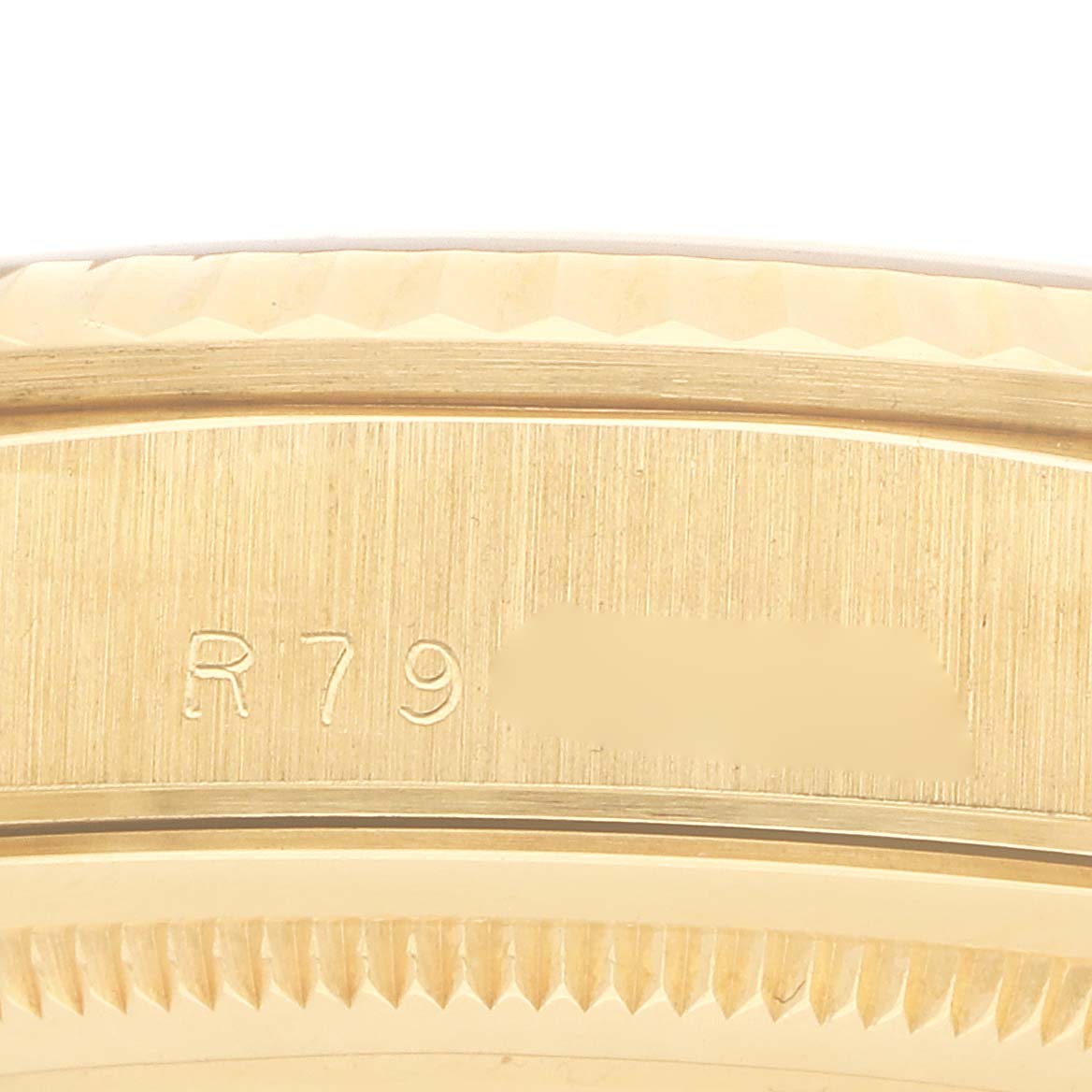 The image shows a close-up of the engraved side of a Rolex President 18238 Men's Yellow Gold Champagne Dial model watch, focusing on the serial number area.