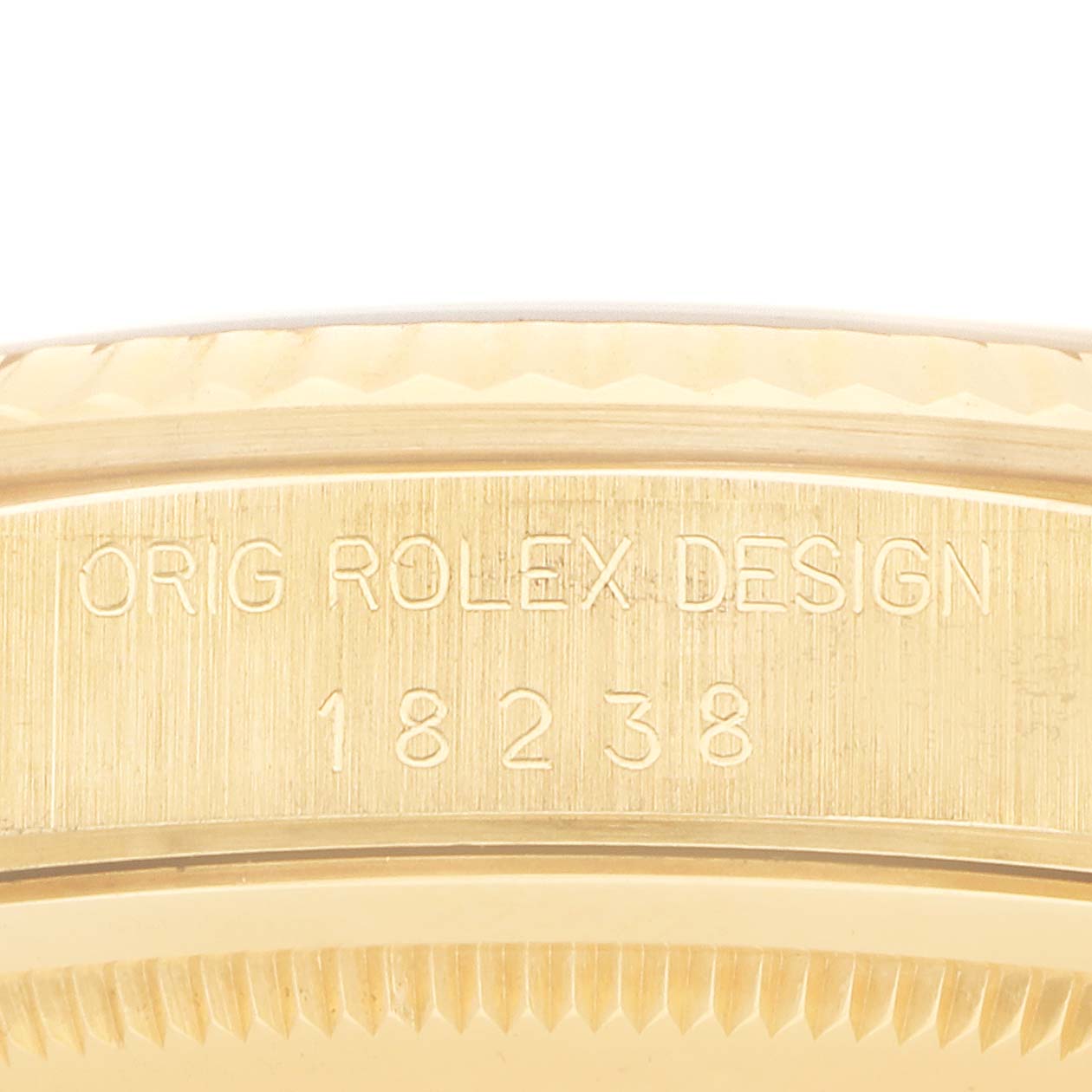 The image shows a close-up of the case edge of a Rolex President 18238 Men's Yellow Gold Champagne Dial model, featuring engraved text and partially visible fluted bezel.