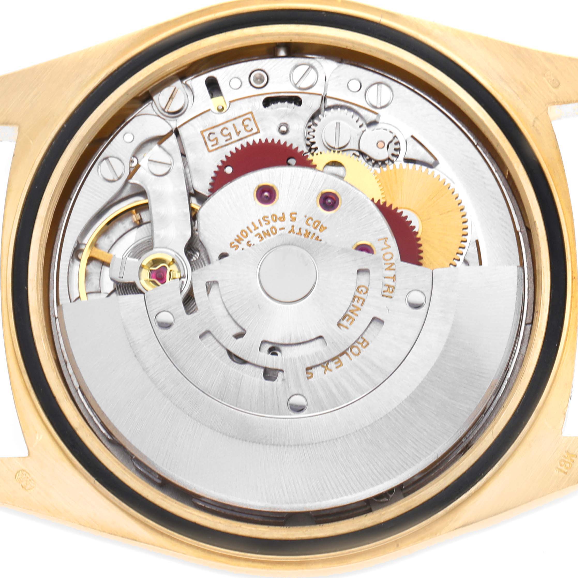 The image shows the inner mechanism of a Rolex President 18238 Men's Yellow Gold Champagne Dial watch with its movement and gears visible from the back.