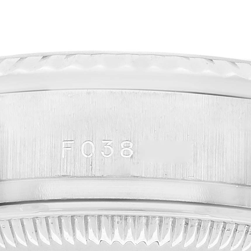 This image shows a close-up of the side of a President model Rolex watch, highlighting its engravings and the bezel.