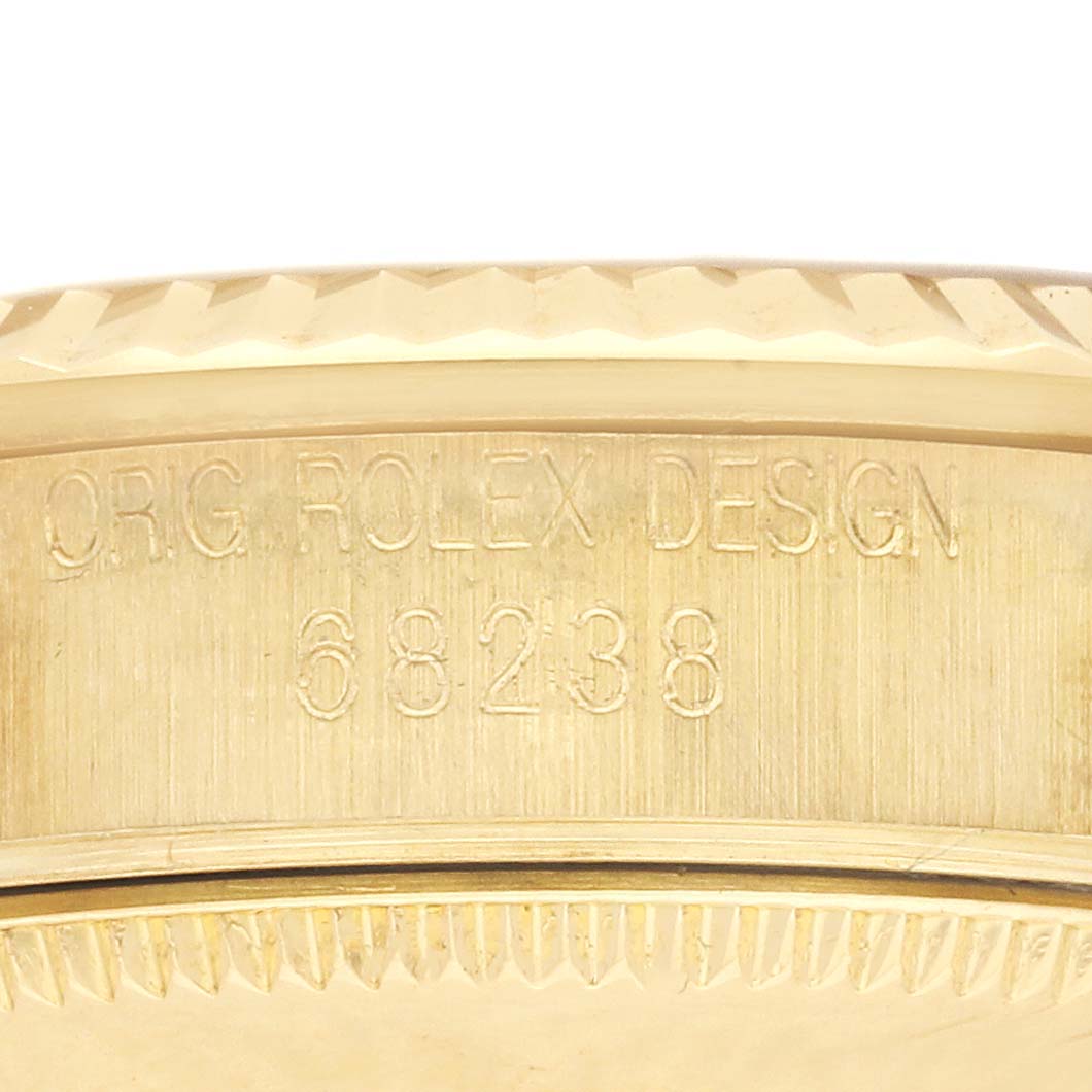 The image shows a close-up of the side of a Rolex President 68238 Women's Yellow Gold Champagne Dial 68238 Women's Yellow Gold Champagne Dial watch with the model number 68238 engraved.