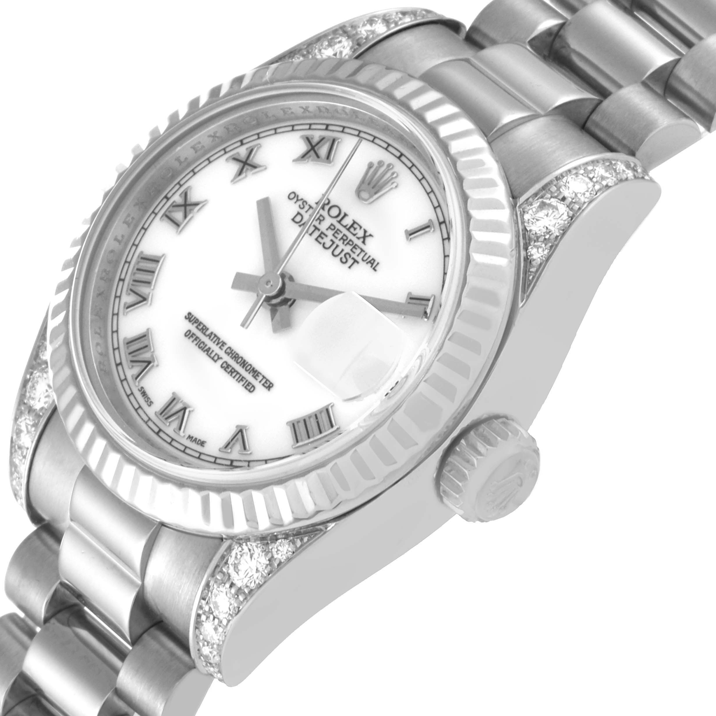 This image shows the dial, fluted bezel, crown, and part of the bracelet of the Rolex President 179239 Women's White Gold White Dial 179239 Women's White Gold White Dial model watch at an angled view.