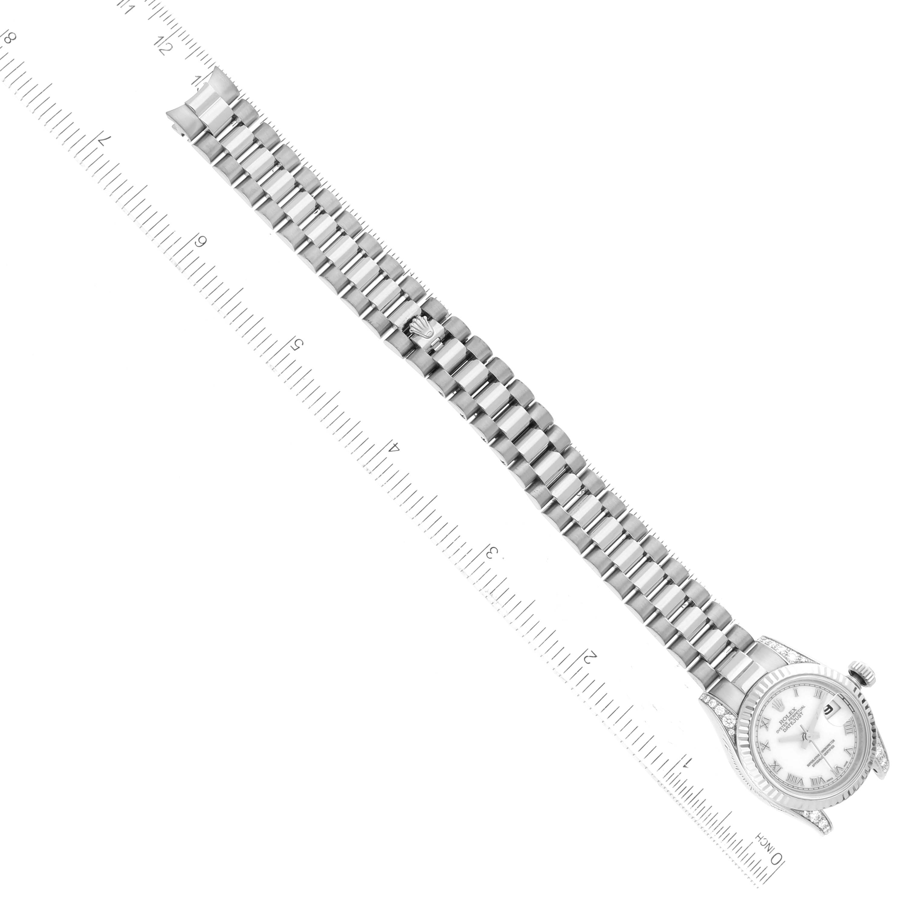 The image shows the full length of a Rolex President 179239 Women's White Gold White Dial 179239 Women's White Gold White Dial model watch laid flat with its band and face visible, alongside a ruler for scale.