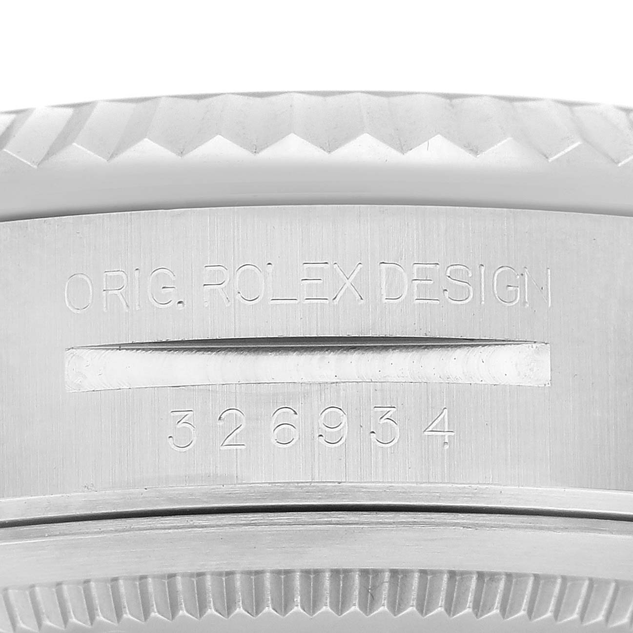 This image shows a close-up of the side of the Rolex Sky-Dweller 326934 Men's Stainless Steel Blue Dial 326934 Men's Stainless Steel Blue Dial, displaying the model number 326934 and "ORIG. ROLEX DESIGN" engraving.