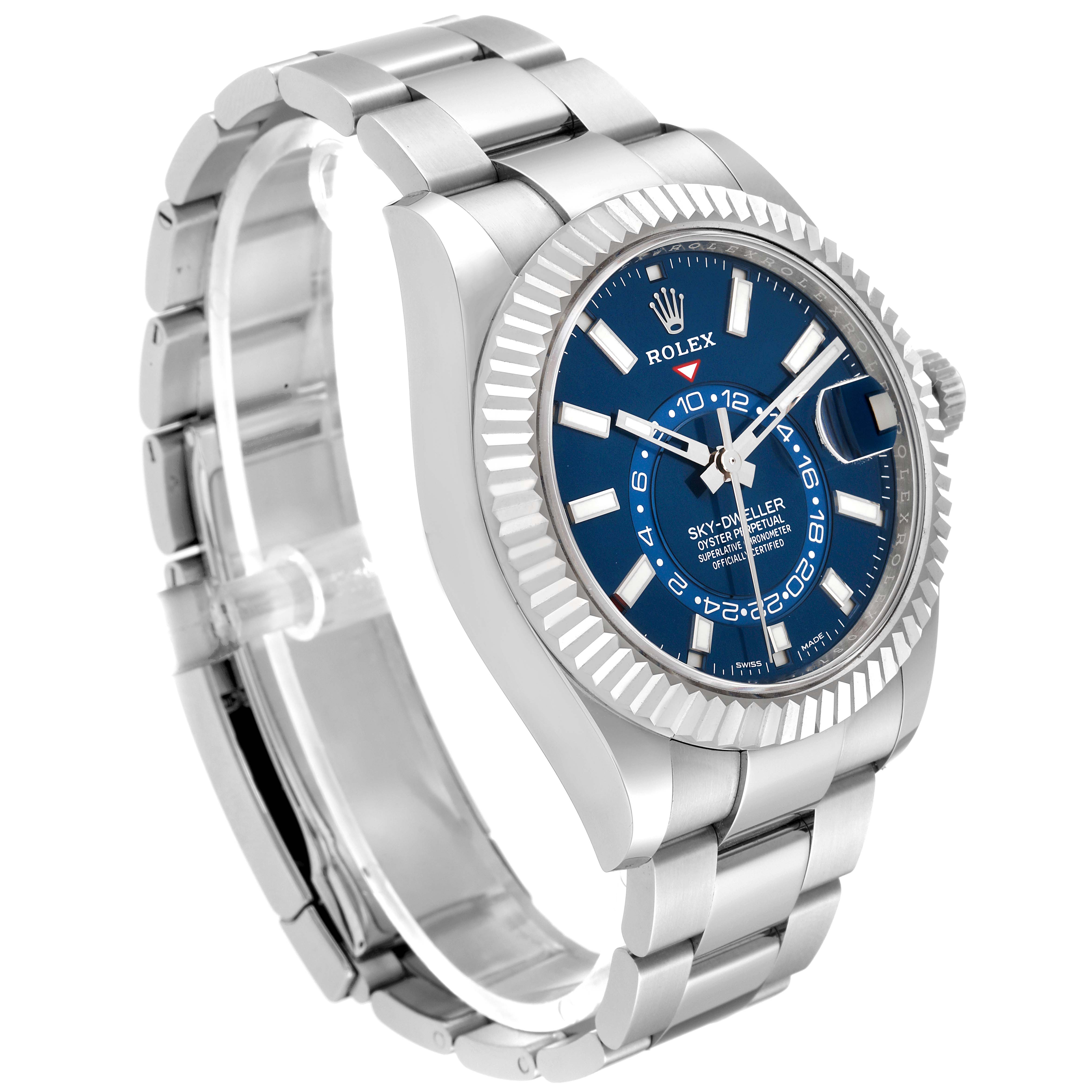 The image shows a side angle view of a Rolex Sky-Dweller 326934 Men's Stainless Steel Blue Dial 326934 Men's Stainless Steel Blue Dial watch, highlighting its blue dial, fluted bezel, and stainless steel bracelet.