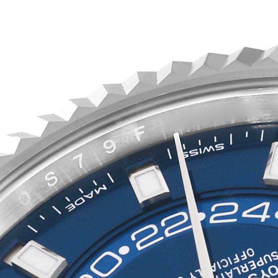 The image shows a close-up of the bezel and dial of the Rolex Sky-Dweller 326934 Men's Stainless Steel Blue Dial 326934 Men's Stainless Steel Blue Dial watch, featuring part of the hour markers and hands.
