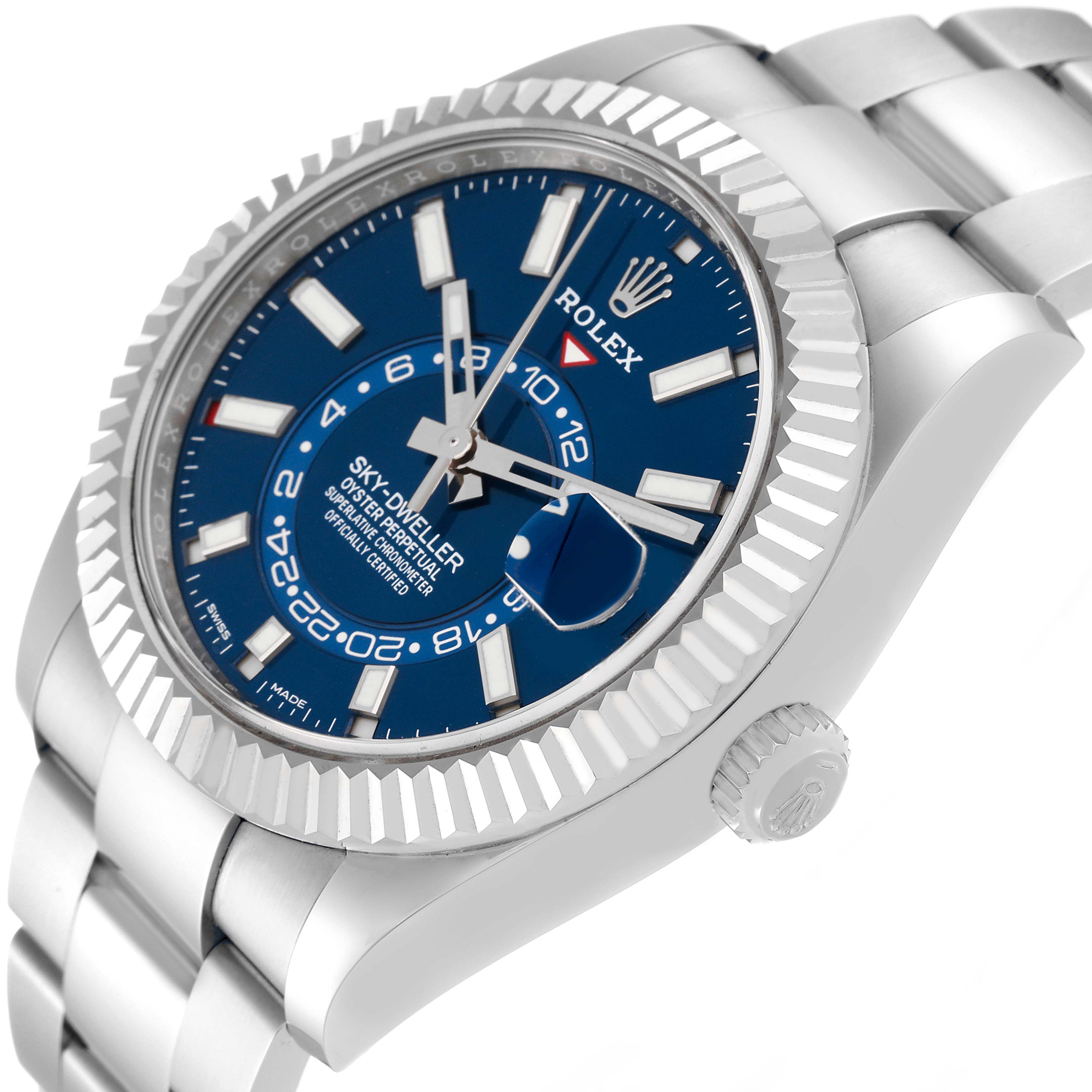 The image shows a side and partial top view of a Rolex Sky-Dweller 326934 Men's Stainless Steel Blue Dial 326934 Men's Stainless Steel Blue Dial watch, highlighting its blue dial, bezel, and metal bracelet.